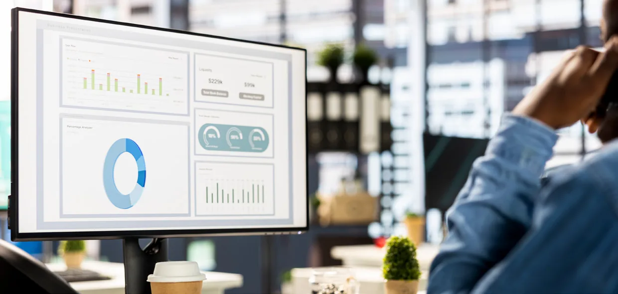 Business dashboards on a workstation in an open-plan office