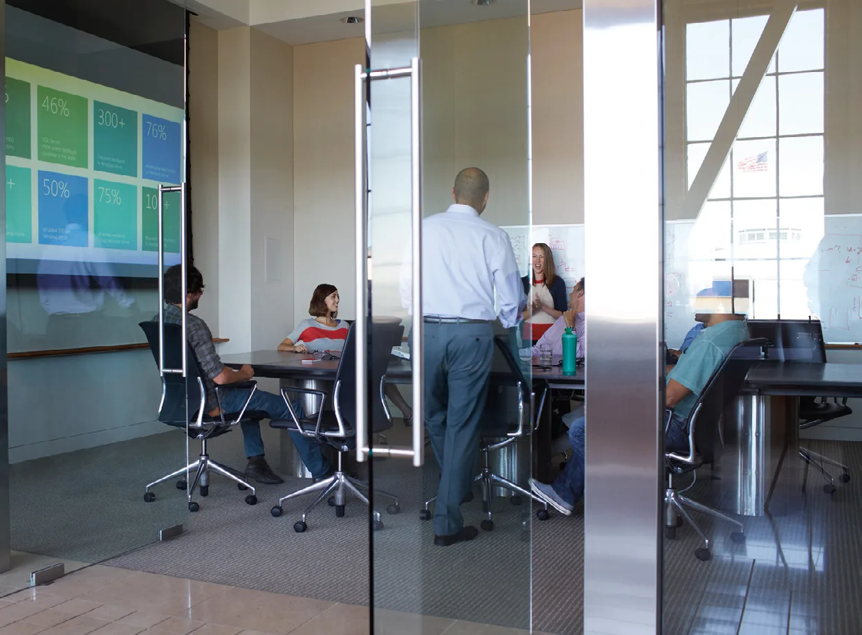 Consultants working with a client team in a meeting room